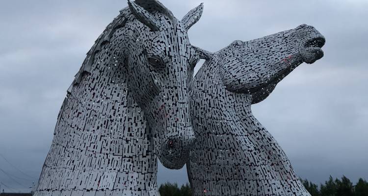 Two horsehead sculptures made of metallic pieces.