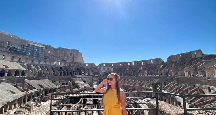 Woman posing inside the Colosseum with bright sunlight.