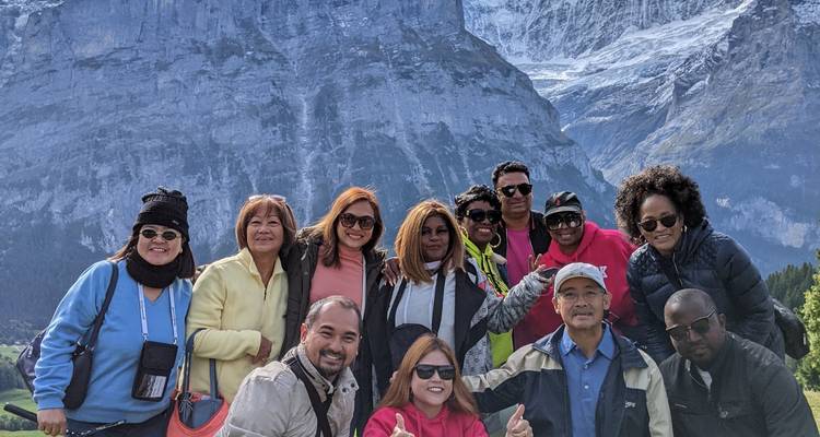 Group of tourists with a mountain landscape in the background.