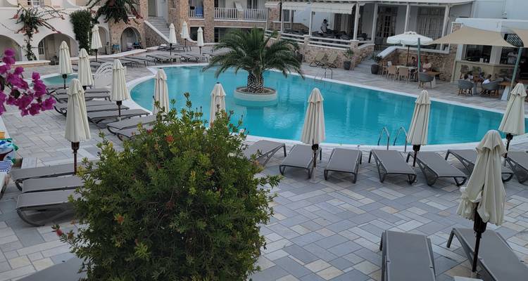 Luxurious pool area surrounded by sun loungers and greenery.