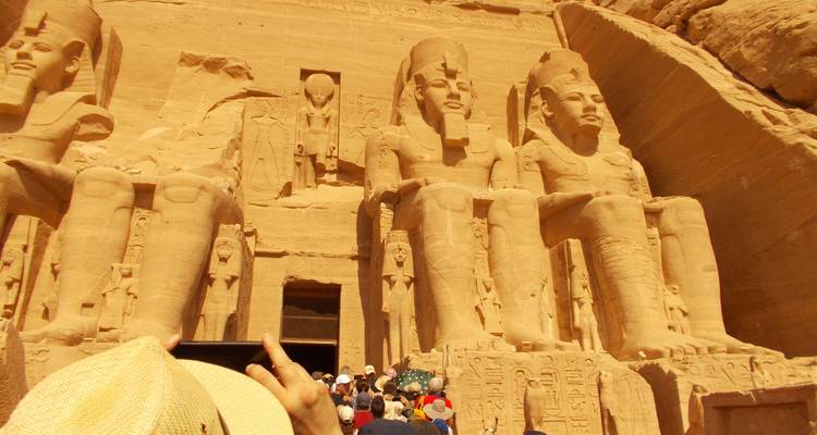 Majestic ancient temple facade with large statues and carvings.