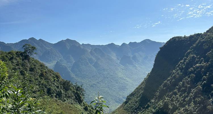 Mountainous landscape with clear blue sky and lush greenery.