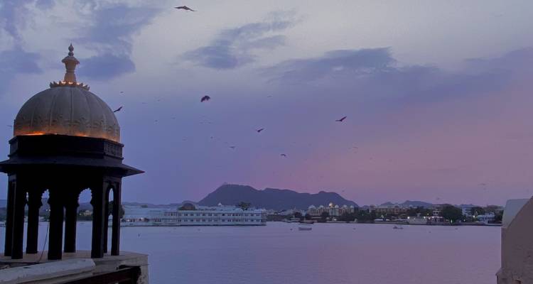 Silhouette of a dome structure against a colorful sunset