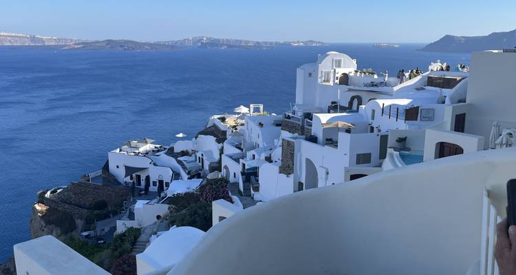 White-washed buildings on cliffs overlooking the Aegean Sea.