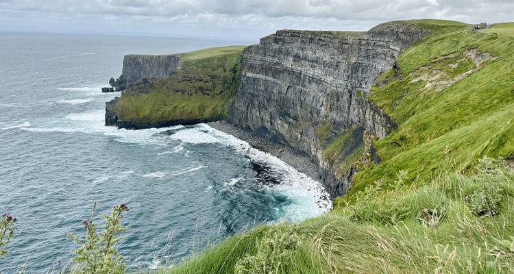 Cliffs of Moher extending into the sea.