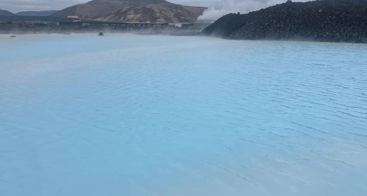 Blue lagoon with geothermal steam rising.