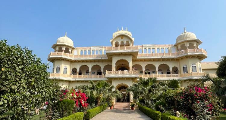A grand palace with lush gardens and flowers.