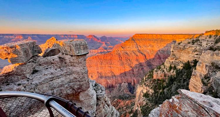 Grand Canyon view with rock formations and sunset lighting.