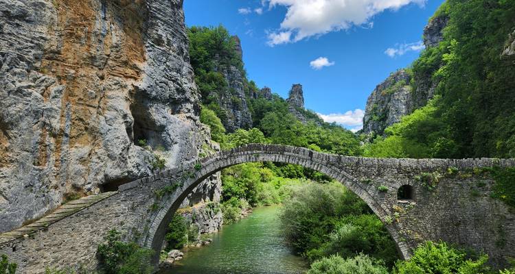 Beautiful stone bridge surrounded by a rugged landscape.