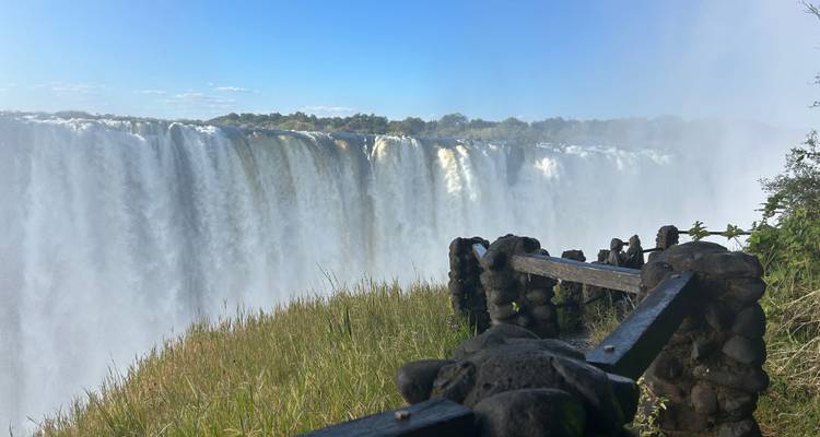 View of a large waterfall with mist and lush surroundings.