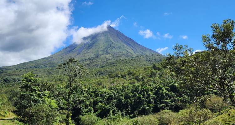 Majestic volcano with lush greenery in the foreground.