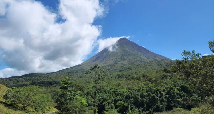 A beautiful view of a volcano surrounded by lush vegetation.