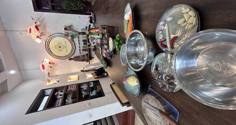 Cooking items laid out on a long table inside a home.