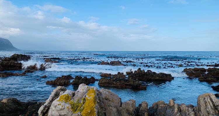 Rocky coastline with ocean waves crashing onto the rocks.
