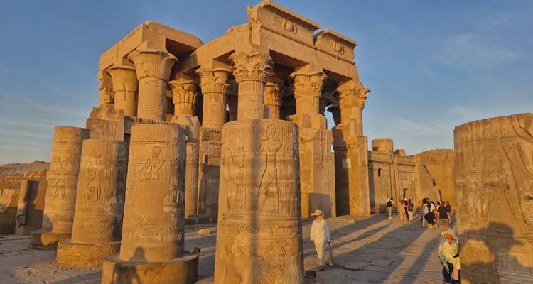 Visitors explore the Temple of Kom Ombo in warm sunset light.