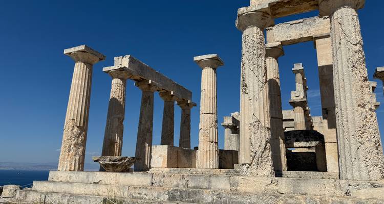 Ancient Greek temple ruins with a blue sky.