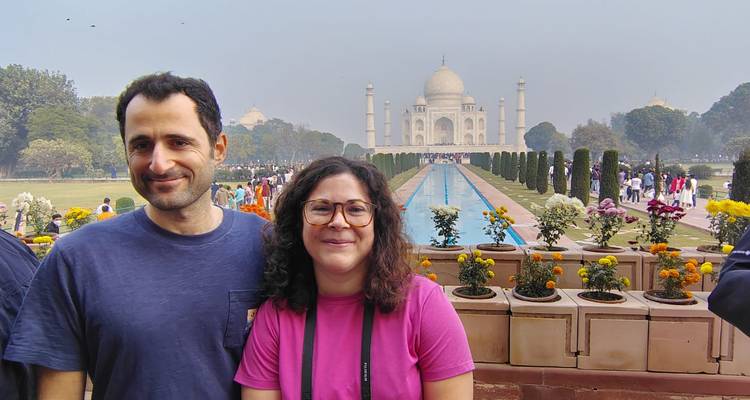 Two people posing in front of the Taj Mahal.