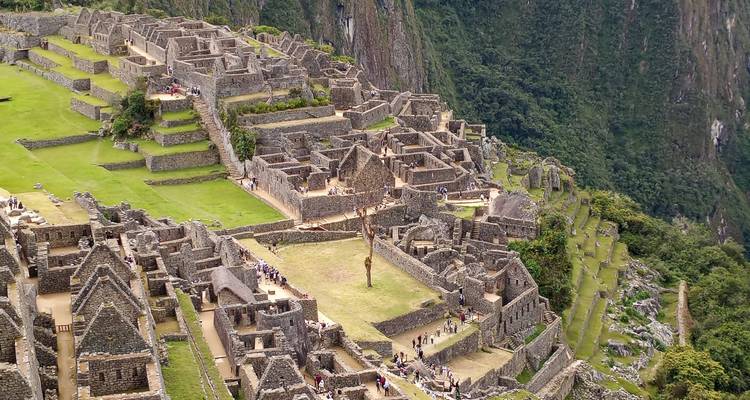 An aerial view of Machu Picchu with ancient ruins and lush landscape.