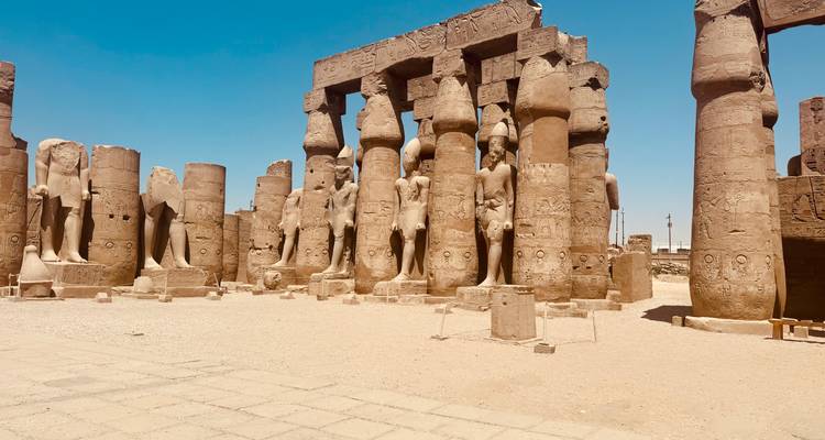 Ancient temple ruins with large columns and statues.