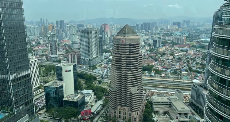 Skyscrapers and city landscape with a hazy sky.