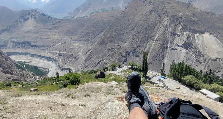 Scenic mountain view with a person’s feet in the foreground.