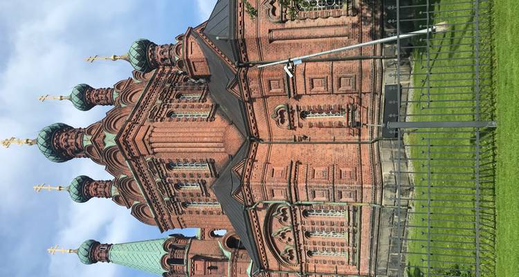 Orthodox church with prominent domes and intricate brickwork.