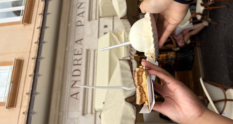 Desserts held with a backdrop of a dessert shop named Andrea Pans.