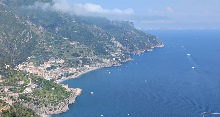 Scenic view of a coastline with buildings and hills