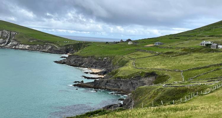 Scenic coastal view of green hills and the ocean.