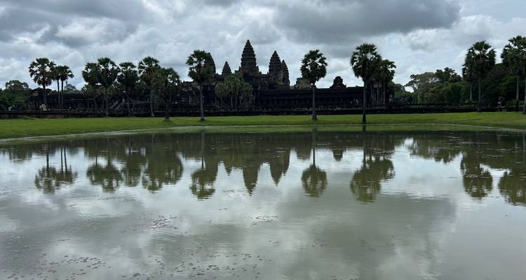 Reflection of Angkor Wat temple on the pond with cloudy sky.