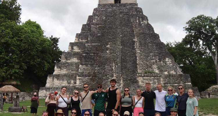 Large group posing in front of an ancient Mayan pyramid.