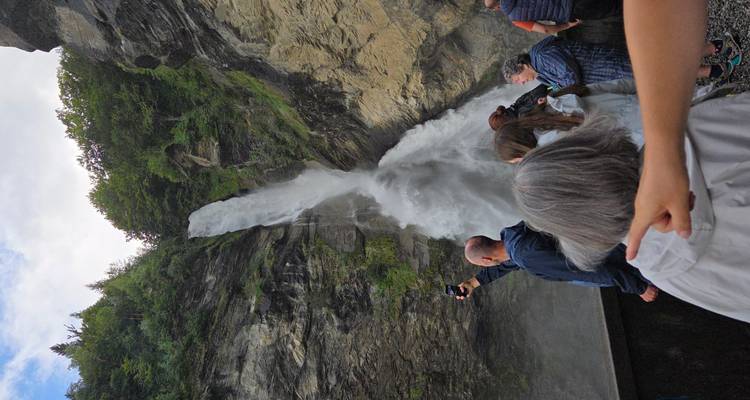 Tourists viewing a large waterfall