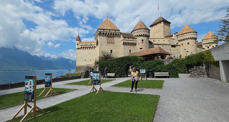 Chateau with mountains and lake in the background