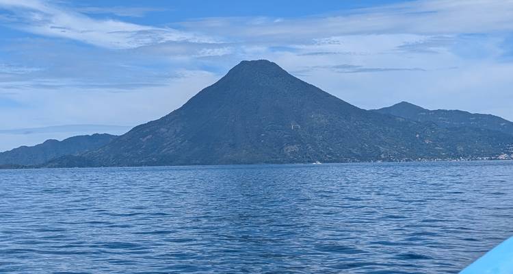 Volcanic mountain view over a lake under a clear sky