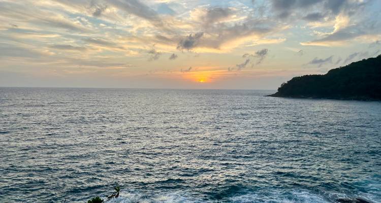 Beautiful ocean sunset with scattered clouds