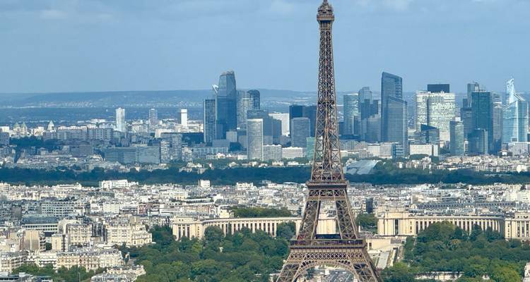 The Eiffel Tower in Paris with a cityscape backdrop.