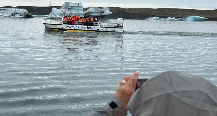 Boat tour among icebergs on a glacial lagoon.