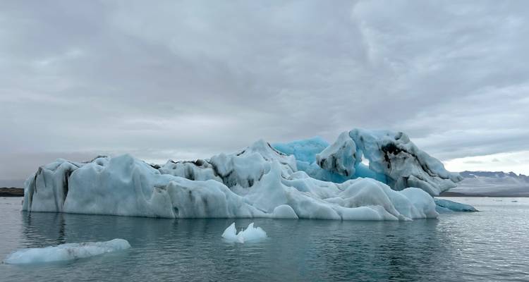 Scenic view of icebergs in a calm glacial lagoon.
