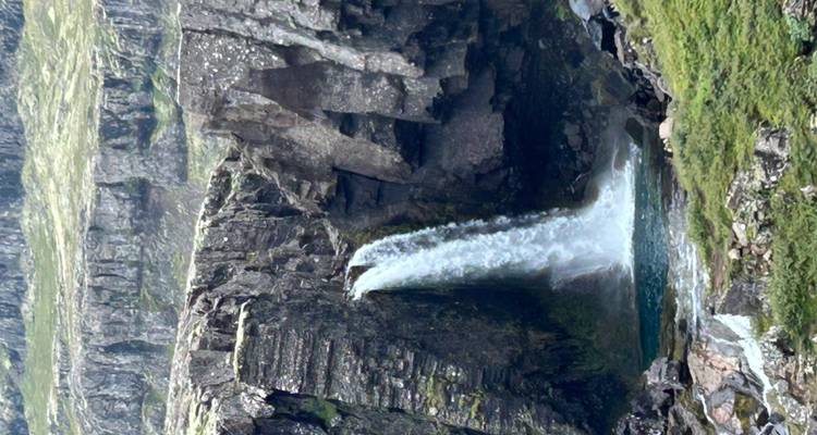 Waterfall cascading down a rocky cliff.
