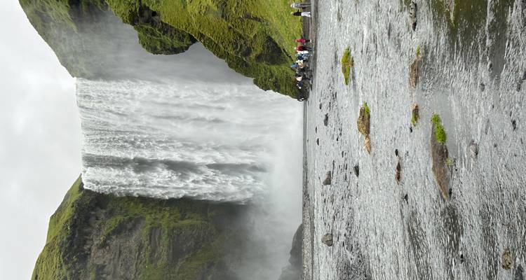 Large waterfall creating mist at the base.