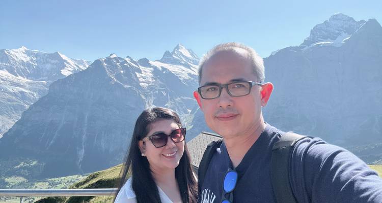 Couple posing with a backdrop of the Swiss Alps.