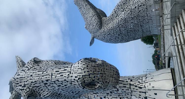 The Kelpies, large equine sculptures under a blue sky.