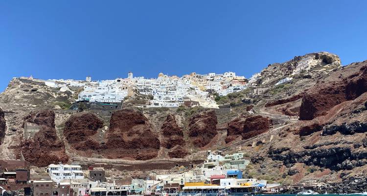 A picturesque view of a cliffside village with whitewashed houses.
