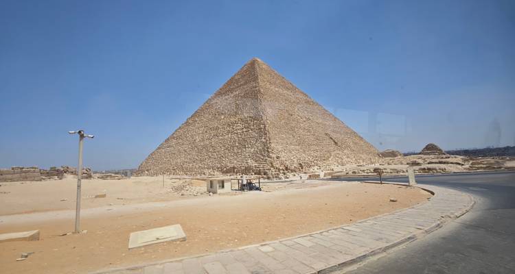 Close-up view of a pyramid at Giza under a blue sky.