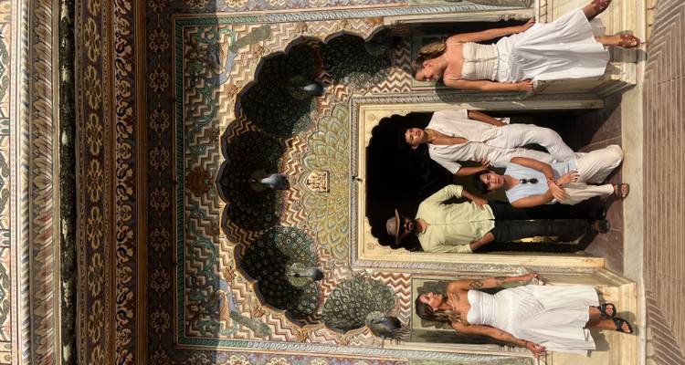 Group posing in front of an ornately decorated doorway.