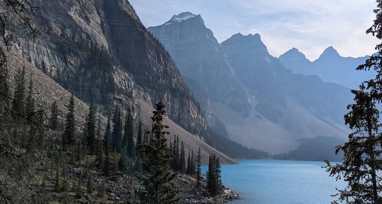 Mountain lake with clear blue water surrounded by rocky peaks.