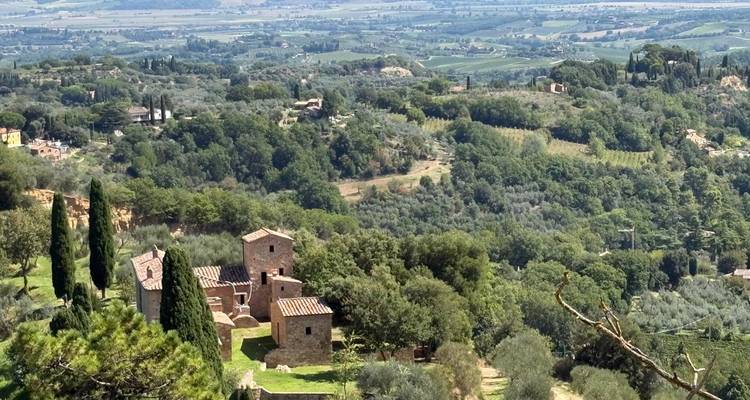 Tuscany's rolling hills with a picturesque village.