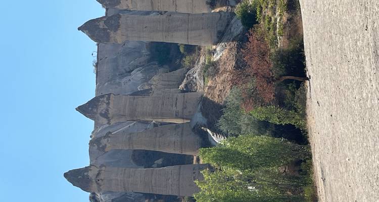 Unique tall rock formations against a clear sky.