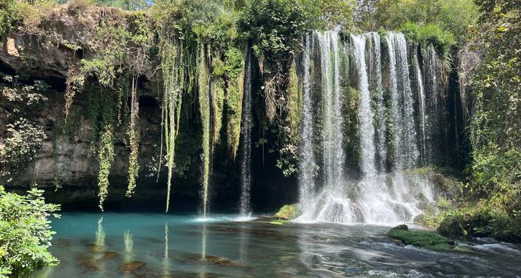 Beautiful waterfall in a lush green area.