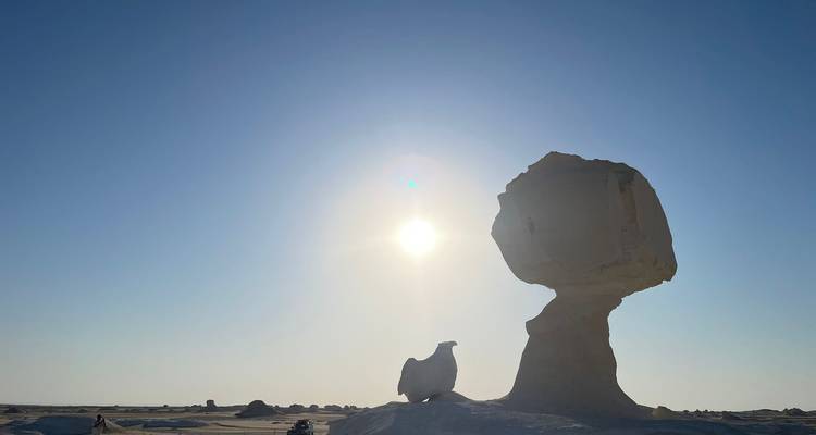 Unique rock formations in a desert under the sun.